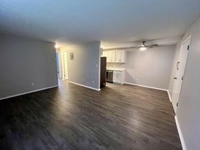 Chardon apartment for rent - an empty living room with wood floors and a kitchen