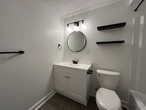 Northfield apartment for rent - a bathroom with a toilet and a sink and a mirror