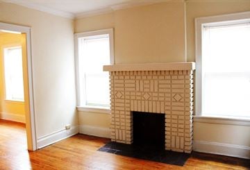 Cleveland Heights apartment for rent - a living room with a fireplace and a wooden floor