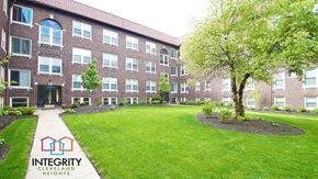 Cleveland Heights apartment for rent - an exterior view of an apartment building with a lawn and tree