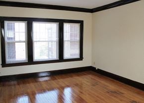 Cleveland Heights apartment for rent - an empty room with wooden floors and three windows