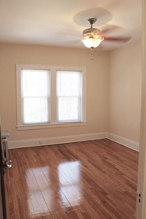 Cleveland Heights apartment for rent - an empty room with a ceiling fan and two windows
