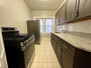 Cleveland Heights apartment for rent - Mapleview kitchen with espresso cabinets, tile flooring, and granite counters.