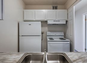 Mentor-On-The-Lake apartment for rent - a kitchen with white appliances and white cabinets and a sink