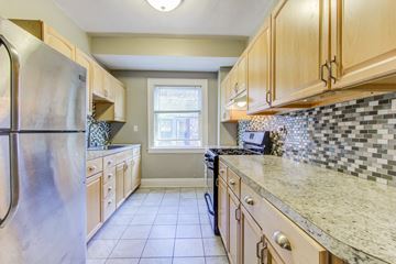 Cleveland Heights apartment for rent - a kitchen with wooden cabinets and granite counter tops