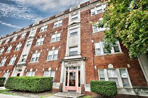 Cleveland apartment for rent - a red brick apartment building with pink doors and windows