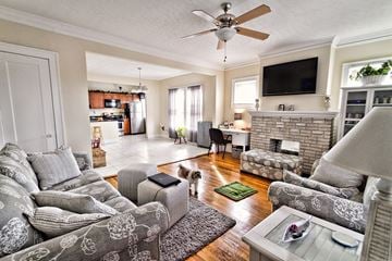 Cleveland apartment for rent - a living room with couches and a fireplace and a ceiling fan
