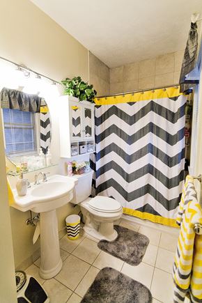 Cleveland apartment for rent - a bathroom with a black and white shower curtain and a sink