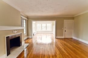Cleveland apartment for rent - an empty living room with a fireplace and wooden floors