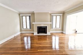 Cleveland apartment for rent - an empty living room with a fireplace and wooden floors