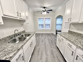 Cleveland Heights apartment for rent - An updated kitchen with white cabinets and a granite countertop.