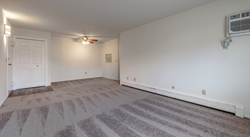 Mentor-On-The-Lake apartment for rent - the living room and dining room of an apartment with carpet and a ceiling fan