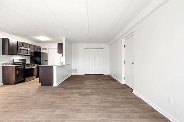 Medina apartment for rent - A kitchen with dark brown cabinets and white walls.