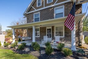 Chagrin Falls triplex for rent - A house with a flag on the porch.