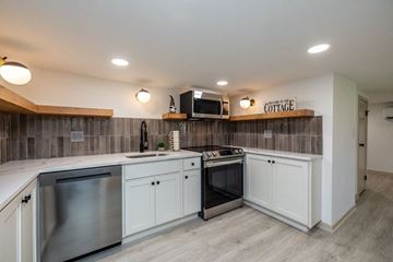Chagrin Falls triplex for rent - A kitchen with a stainless steel dishwasher and oven.