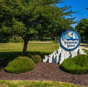 Mentor-On-The-Lake apartment for rent - a sign for the northwest manor mall in front of a tree