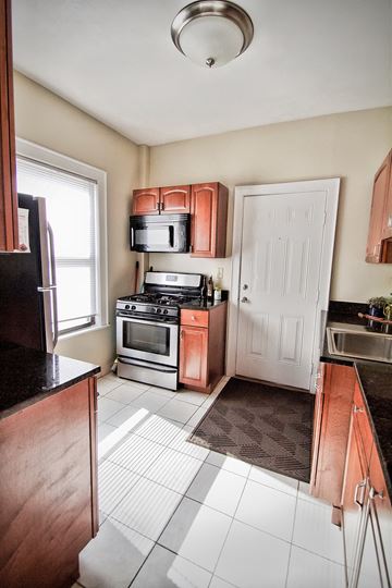 Lakewood apartment for rent - a kitchen with wooden cabinets and stainless steel appliances