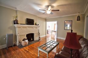 Lakewood apartment for rent - an empty living room with a fireplace and a ceiling fan