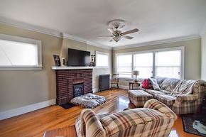 Lakewood apartment for rent - a living room with couches and a fireplace and a ceiling fan
