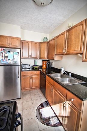 Lakewood apartment for rent - a kitchen with wooden cabinets and a stainless steel refrigerator