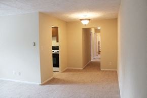 Cleveland Heights apartment for rent - an empty living room with a kitchen and an open hallway