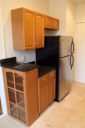 Cleveland Heights apartment for rent - a small kitchen with a refrigerator and cabinets