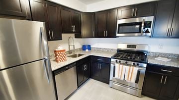 Westlake apartment for rent - a kitchen with stainless steel appliances and black cabinets