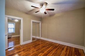 Lakewood apartment for rent - the living room of an empty house with a ceiling fan