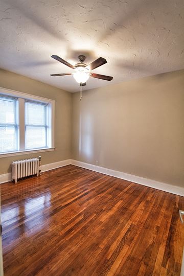 Lakewood apartment for rent - the living room of an empty house with a ceiling fan