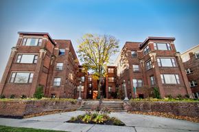 Lakewood apartment for rent - a row of brick apartment buildings with a tree in the middle