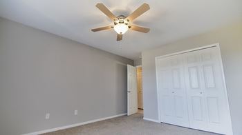 Bedroom with a ceiling fan and a closet