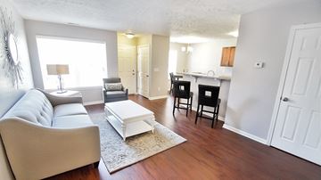 Cleveland apartment for rent - a living room with a couch and a table in front of a kitchen