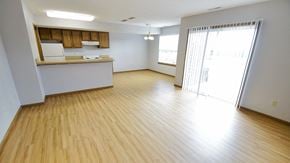 Wadsworth townhouse for rent - an empty living room and kitchen with wood flooring