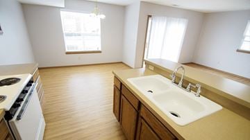 Wadsworth townhouse for rent - an empty kitchen with a sink and a stove and a window