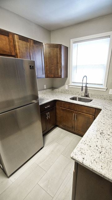 Lakewood apartment for rent - a kitchen with wooden cabinets and a stainless steel refrigerator