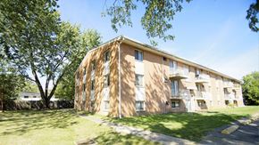 Berea apartment for rent - A large apartment building with a tree in front of it.
