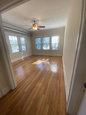 Cleveland Heights apartment for rent - an empty living room with wood floors and a ceiling fan