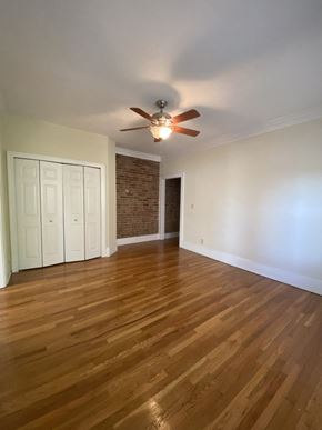 Cleveland Heights apartment for rent - an empty living room with wooden floors and a ceiling fan