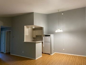 Berea apartment for rent - A kitchen with a refrigerator, microwave, and oven.