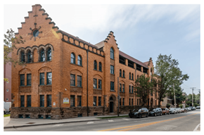 Lakewood apartment for rent - A red brick building with a clock on the top left side.