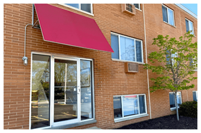 Lakewood apartment for rent - A red awning is attached to a brick building.