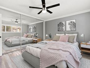 Los Angeles apartment for rent - Carpeted bedroom with ceiling fan and large mirrored closet.