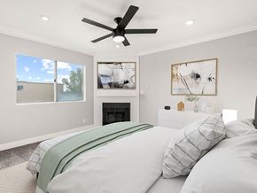 Los Angeles apartment for rent - Carpeted bedroom with ceiling fan and private fireplace.
