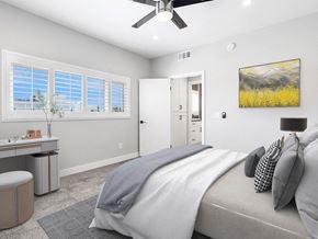 Los Angeles apartment for rent - Carpeted bedroom with ceiling fan and large windows for natural light.