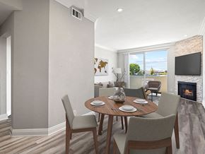 Los Angeles apartment for rent - Hardwood floored dining room with view of balcony and stone walled fireplace.