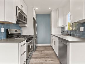 Los Angeles apartment for rent - Blue tiled kitchen with stainless steel oven, microwave, and fridge.