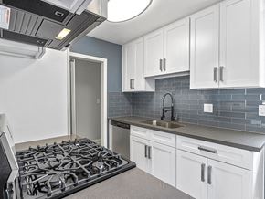Los Angeles apartment for rent - Kitchen with blue tile backsplash and stainless steel Stove, Oven, and fixtures.