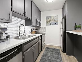 Sherman Oaks apartment for rent - White tiled kitchen with stainless steel fridge, microwave, and oven.
