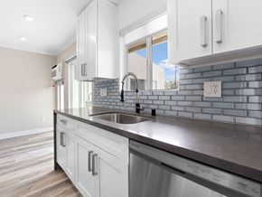 Los Angeles apartment for rent - Blue tiled kitchen with stainless steel oven, fridge, dish washer, and fixtures.