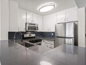 Sherman Oaks apartment for rent - Kitchen with stainless steel oven, microwave, and fridge.